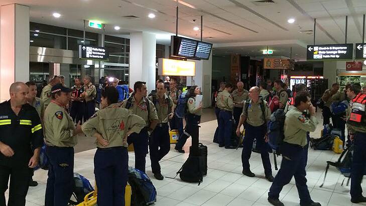 Members of Queensland Urban Search and Rescue teams arrive at Cairns Airport. Photo: Cameron Atfield