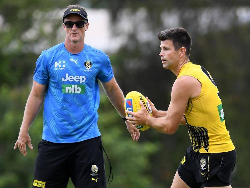 Damien Hardwick (l) and Trent Cotchin have put off-field issues aside to focus on another flag win.