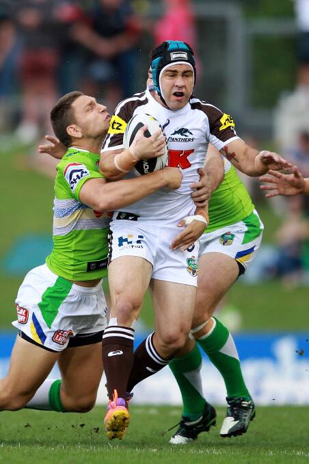SYDNEY, AUSTRALIA - APRIL 05: Jamie Soward of the Panthers is tackled during the round five NRL match between the Penrith Panthers and Canberra Raiders at Sportingbet Stadium on April 5, 2014 in Sydney, Australia. (Photo by Matt Blyth/Getty Images)