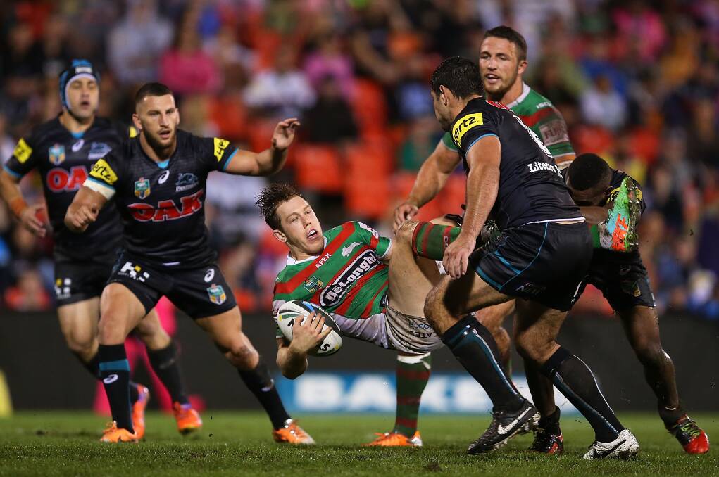 SYDNEY, AUSTRALIA - APRIL 11: Cameron McInnes of the Rabbitohs is tackled by the Panthers defence during the round 6 NRL match between the Penrith Panthers and the South Sydney Rabbitohs at Sportingbet Stadium on April 11, 2014 in Sydney, Australia. (Photo by Brendon Thorne/Getty Images)