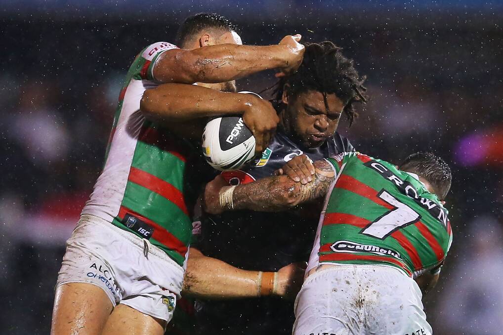SYDNEY, AUSTRALIA - APRIL 11: Jamal Idris of the Panthers is tackled by the Panthers defence during the round 6 NRL match between the Penrith Panthers and the South Sydney Rabbitohs at Sportingbet Stadium on April 11, 2014 in Sydney, Australia. (Photo by Brendon Thorne/Getty Images)