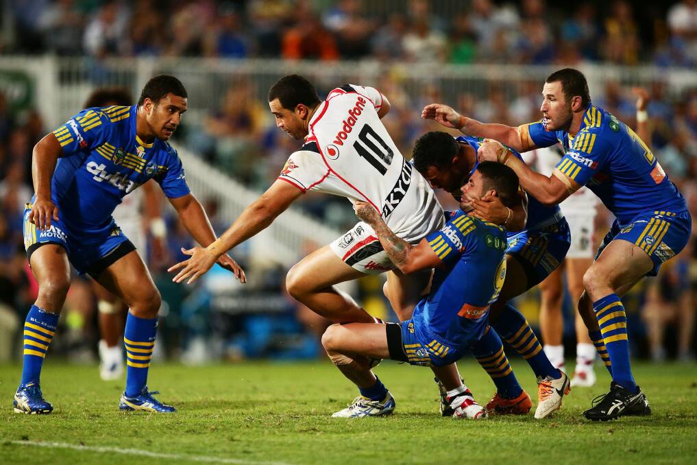 Good start: Peni Terepo (left) goes in for a tackle against the New Zealand Warriors. Picture: Getty Images
