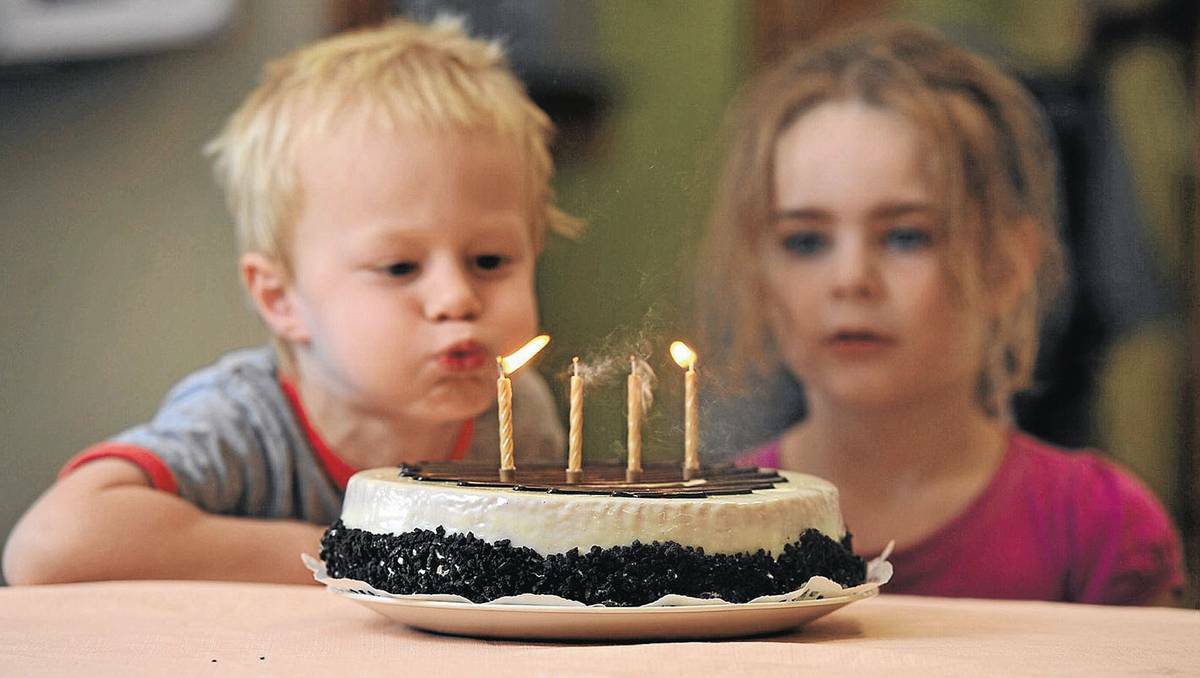 Austin Smit blows out the candles on a cake at Amy Hurd Child Care Centre in Kooringal while his friend Sarah Hardy, 4, looks on. Photo: ADDISON HAMILTON