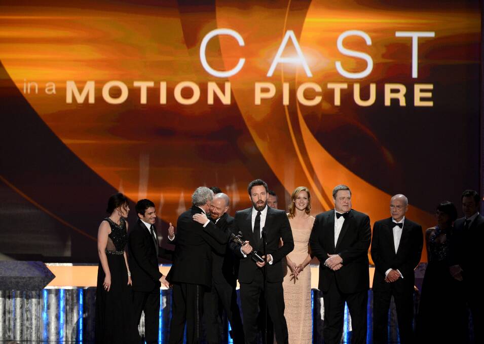 Actors Clea DuVall; Christopher Denham; Victor Garber; Bryan Cranston; Ben Affleck; Kerry Bishe; John Goodman; and Alan Arkin accept the award for Outstanding Performance by a Cast in a Motion Picture for 'Argo'. Photo by Mark Davis/Getty Images